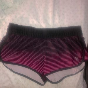2 HURLEY beach wear shorts. One pink and black.     The other one is purple.